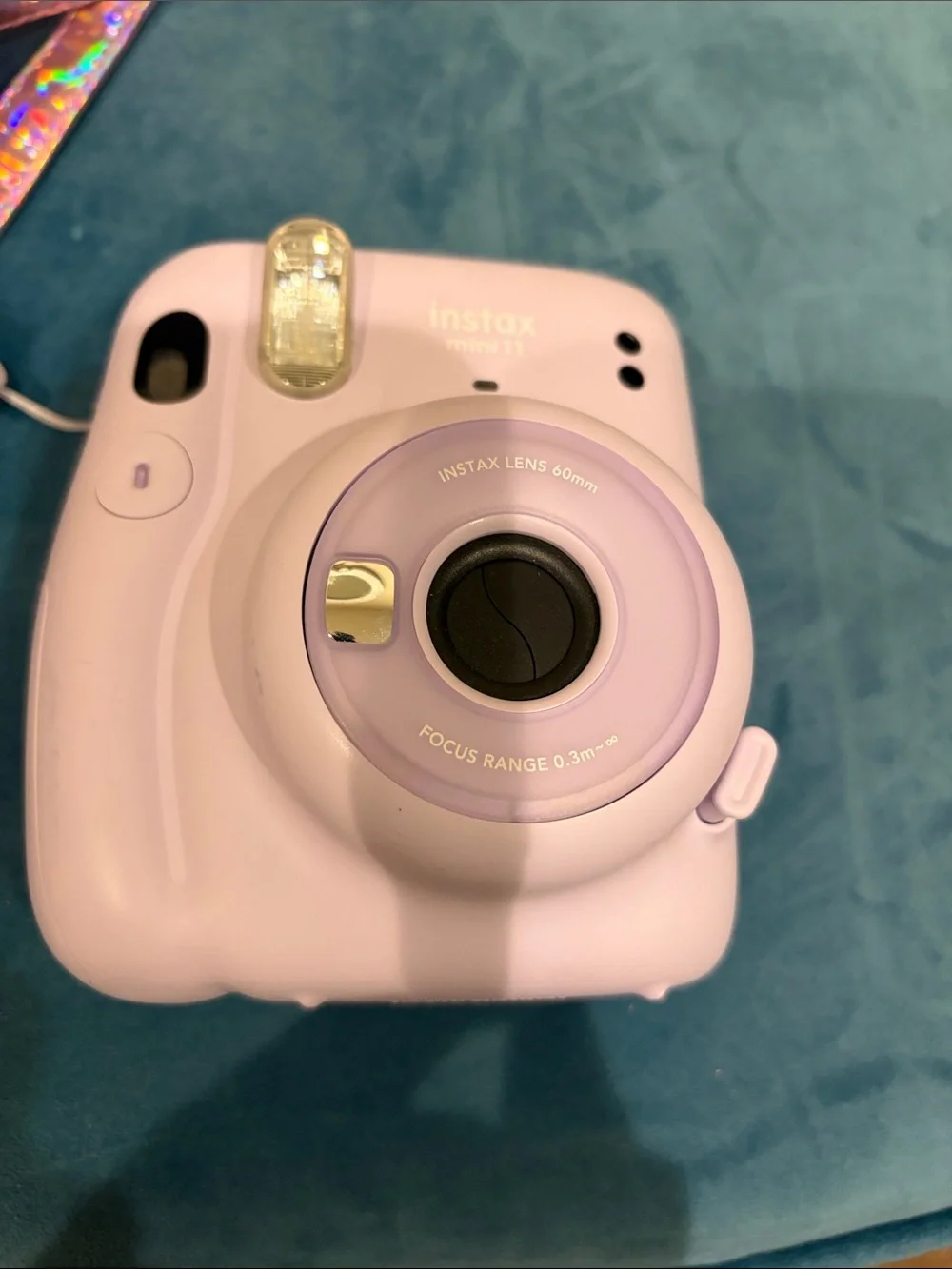 Fujifilm instax mini 11 camera with stylish metallic cross body bag.
